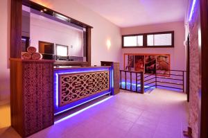 a room with a bar with a blue light at City's Hill Hotel in Kuşadası