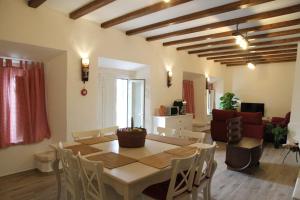 a dining room with a table and a living room at Casas de São Lázaro in Juromenha