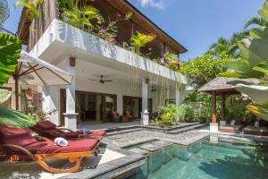 a villa with a swimming pool and a house at Villa Sedap Malam Seminyak by Best Deals Asia Hospitality in Seminyak