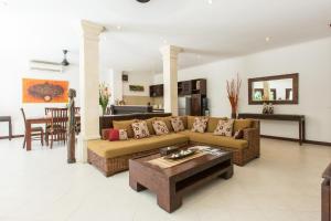 a living room with a couch and a table at Villa Sedap Malam Seminyak by Best Deals Asia Hospitality in Seminyak