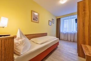 Postel nebo postele na pokoji v ubytování Hotel Windsor