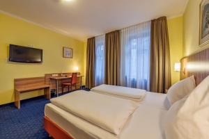Postel nebo postele na pokoji v ubytování Hotel Windsor