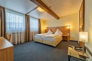 Postel nebo postele na pokoji v ubytování Hotel Windsor