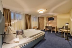 Postel nebo postele na pokoji v ubytování Hotel Windsor