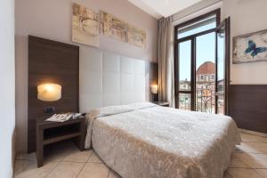 a hotel room with a bed and a window at Hotel Bellavista in Florence