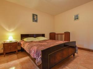 a bedroom with a large bed and a night stand at Holiday home with private garden in Cazals