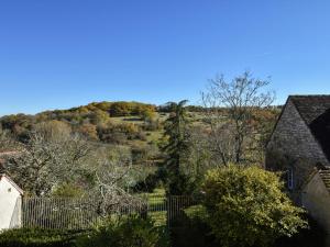 a view of a hill with a house and trees at Beautiful holiday home near the forest in Labastide-Murat
