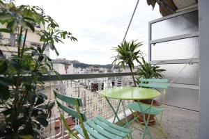 a balcony with a green table and chairs at Athens central apartment with Acropolis views! - SQ1 in Athens