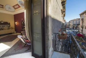 a balcony with a view of a city at Catania Inn Rooms in Catania