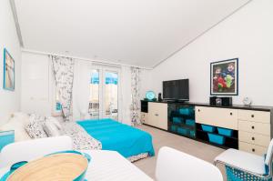 a living room with a bed and a tv at Apartments Carmen & Tosca in Dubrovnik