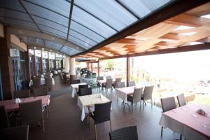 a dining room with tables and chairs and windows at Faustina Hotel & Spa in Güzelçamlı