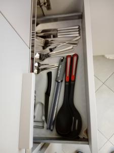 a drawer filled with knives and utensils at Salvia e Timo Rooms in Borso del Grappa