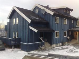 a blue house with a bike parked in front of it at Malvik, Hundhamaren, Trondheim in Malvik