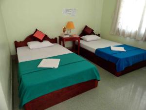 Ένα ή περισσότερα κρεβάτια σε δωμάτιο στο Green Park Village Guesthouse