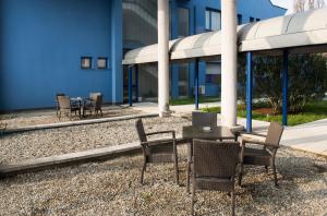 a table and chairs in front of a building at Park Hotel Residence in Crema