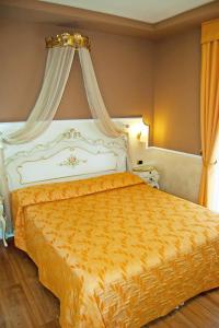Postel nebo postele na pokoji v ubytování Hotel Confine
