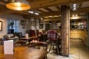 a restaurant with tables and chairs and a bar at The Kestrel by Innkeeper's Collection in Harrogate