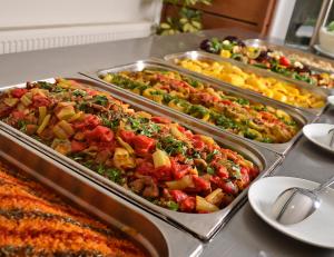 a buffet with several trays of food on a table at City's Hill Hotel in Kuşadası