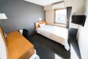 Postel nebo postele na pokoji v ubytování Super Hotel Minami Hikone Ekimae