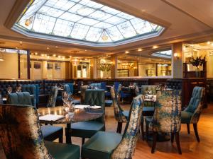 a dining room filled with tables and chairs at The Chester Grosvenor in Chester