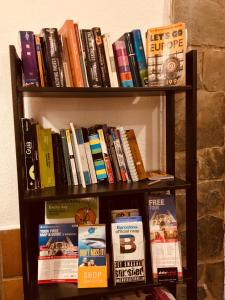 a book shelf filled with lots of books at Hostel New York in Barcelona