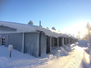 un bâtiment recouvert de neige avec un compteur de stationnement dans l'établissement Ruoktu, à Saariselka