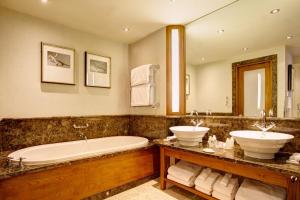 a bathroom with two sinks and a bathtub at The Chester Grosvenor in Chester