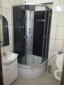 a bathroom with a shower and a toilet and a sink at Penzión Rekrea in Levice
