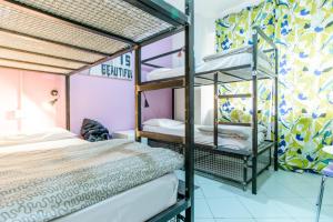 a bed room with two beds and a window at Hostel of the Sun in Naples
