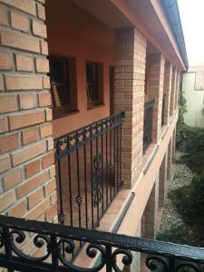 a balcony of a brick building with a black railing at Penzion na Potočnej in Skalica +7 photos