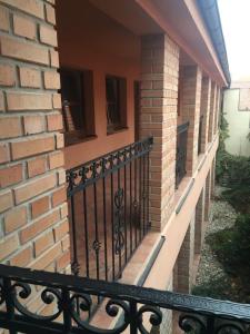 a balcony of a brick building with a black railing at Penzion na Potočnej in Skalica