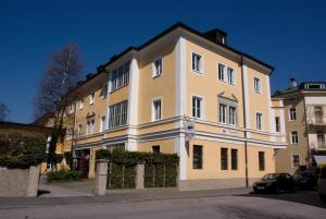 a large building on the side of a street at YoHo - International Youth Hostel in Salzburg