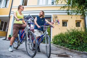 a man and a woman standing with their bikes at YoHo - International Youth Hostel in Salzburg