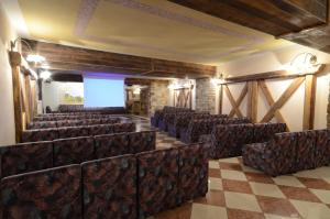 an empty cinema room with chairs and a checkered floor at Hotel Paganella in Andalo