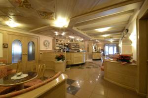 a large kitchen with a table and a counter at Hotel Paganella in Andalo