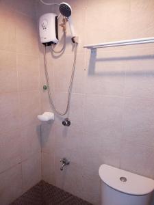 a bathroom with a shower with a toilet in it at 722 Metropolis Tower Unit 212 in Bacolod