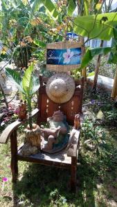 a wooden bench with a doll sitting on it at Nostress Guest House in Mui Ne