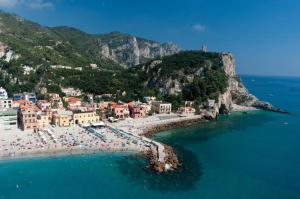 an aerial view of a beach with umbrellas at Sant’Antonio in Finale Ligure