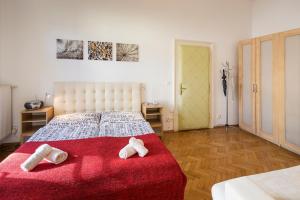 a bedroom with a bed with two towels on it at Dušní Apartments in Prague