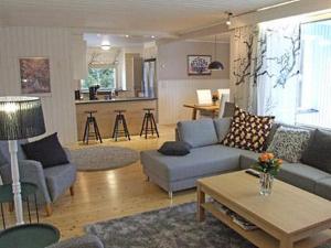 a living room with a couch and a table at Villa Porkka in Kuusamo