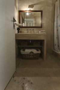 a bathroom with a sink and a mirror at Maison de charme Pampelonne Saint Tropez in Saint-Tropez +20 photos