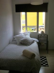 Ένα ή περισσότερα κρεβάτια σε δωμάτιο στο Fano's House - Habitaciones en vivienda particular