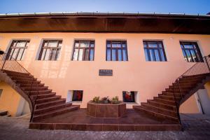 a building with a staircase in front of it at Boul Rosu Residence in Arad