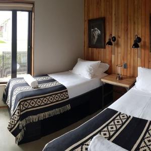 Ένα ή περισσότερα κρεβάτια σε δωμάτιο στο Hostal Boutique Factoria Patagonia