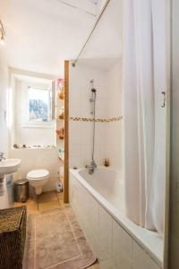a white bathroom with a tub and a toilet at Les Fourges in Saint-Gervais-les-Bains