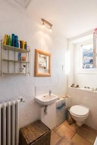 a bathroom with a sink and a toilet and a window at Les Fourges in Saint-Gervais-les-Bains