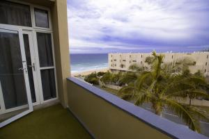a balcony with a view of the beach and the ocean at 901 Umdloti Beach Resort in Umdloti