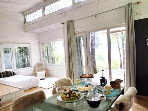 a living room with a table with food on it at Mareas Ralun Lodge in Ralún