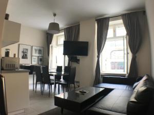 ein Wohnzimmer mit einem Sofa und einem Tisch in der Unterkunft CityAparts - Rynek View 2 Bedrooms Private Apartment - FV in Breslau