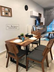 a dining table and chairs in a living room at Le Maison GuestHouse @ Majestic Imperial in Ipoh